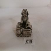 A figure of a dog with silver hallmark and signature