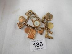 A 9ct gold charm bracelet with 13 gold charms