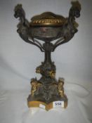 A brass and bronze lamp base surmounted with cherubs and dragons