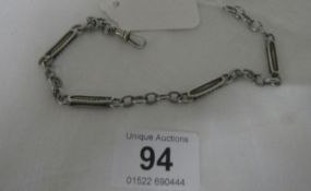 A silver pocket watch chain