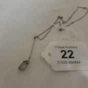 An aquamarine pendant on silver chain