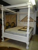 A painted four poster bed