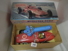A boxed Mercedes Benz toy battery racing car