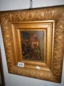 A gilt framed picture on board of a lady and gentleman