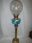 A brass Corinthian column oil lamp with turquoise glass font