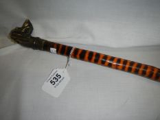 A tiger pattern walking stick with dog head top