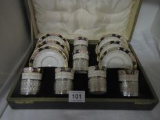 A cased 12 piece porcelain coffee set with silver holders