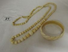 An ivory necklace and bangle