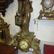 A marble mantel clock with figure of lady playing violin (has key and pendelum)