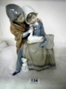 A Lladro figure of boy and girl with dog and duck