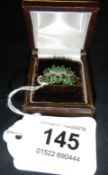 A 16 stone emerald over diamond bar gold ring