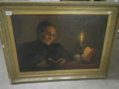 An oil on canvas 'Lady reading by candlelight' signed Cyril Chitty