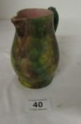 A 19C treacle glaze jug with mask spout