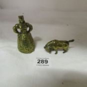 A rare brass crinoline lady bell with legs and a brass bull