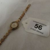 A 9ct gold ladies wristwatch with 9ct gold strap