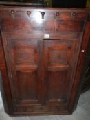 A Georgian oak corner cupboard with 3 drawers