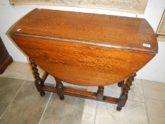 An oak barley twist gate leg table