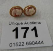 A pair of unmarked yellow metal cameo earrings