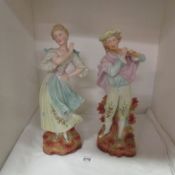 A pair of Germanic bisque porcelain musician and dancer figures