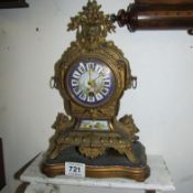 A French mantel clock with hand painted Sevres panels