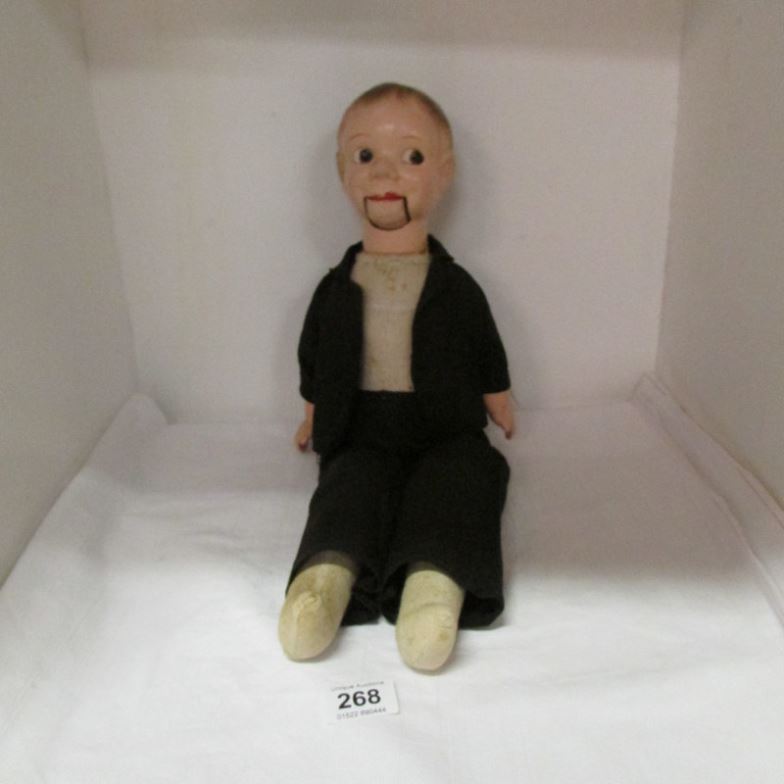 A vintage ventriloquist dummy with composition head