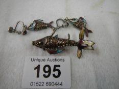 An unmarked silver and enamel articulated fish pendant and earrings