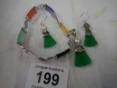 A silver bracelet, silver pendant and silver earrings