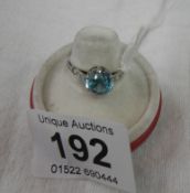 A 9ct gold white ring set blue zircon with diamond set shoulders