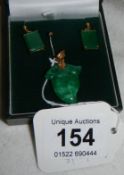 A pair of jade earrings and pendant