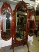 A triple combination mahognay chevel bevel edged mirror