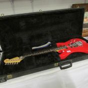 A cased electric guitar