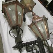 A pair of copper lanterns with wall brackets