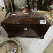 A Victorian rosewood tea caddy with mother of pearl inlay (missing glass bowl)