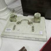 A marble desk stand with glass bottles