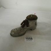 A large plated spelter boot pin cushion and pins