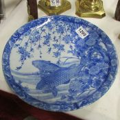 A blue and white Oriental plate decorated with fish