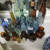 A mixed lot of coloured glass bottles