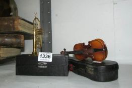 A cased miniature trumpet and violin