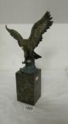 A cold painted bronze eagle on marble plinth