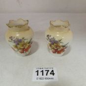 A pair of Doulton Burslem miniature vases
