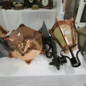 A pair of copper lanterns with wall brackets