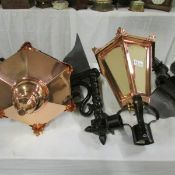 A pair of copper lanterns with wall brackets