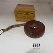 A Chesterman's measuring tape in leather case