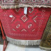 An Afghan wool rug, 1.18cm x 0.70cm