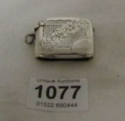 A silver vesta case