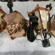 A pair of copper lanterns with wall brackets