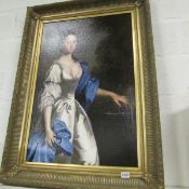 A large gilt framed portrait print of a young woman