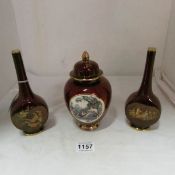 A Carlton ware lustre lidded pot and  a pair of similar vases