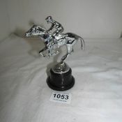 A chrome car mascot being horse and jockey marked AEL