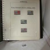 An album of stamps including St.Lucia, Trinidad & Tobago etc